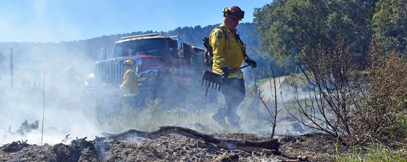 San Mateo County firefighters mopping up a grass fire